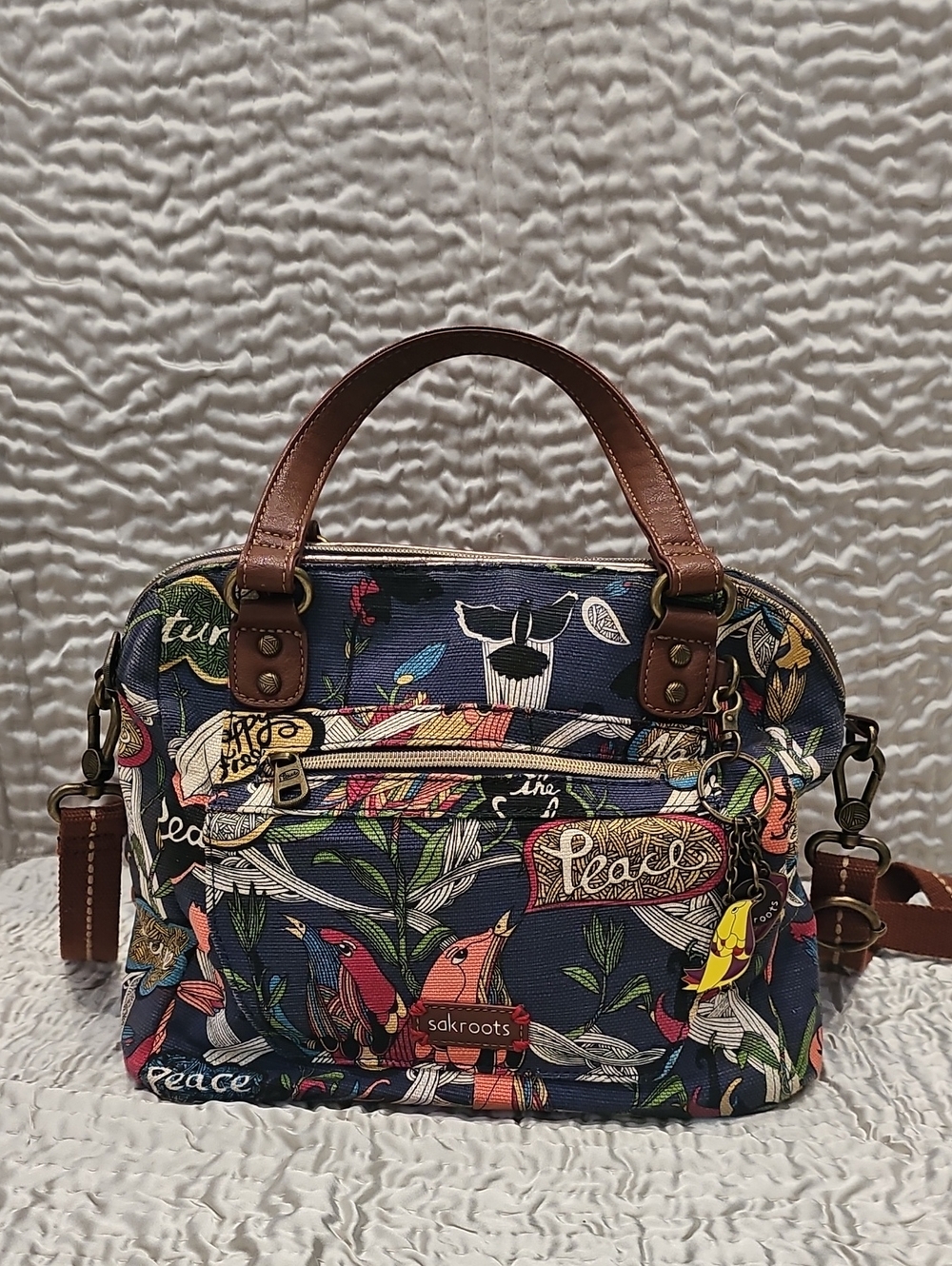 Sakroots Navy Multicolor Floral PEACE bird Crossbody Satchel with Brown Trim